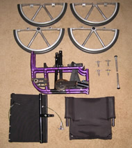 Figure 2.  This picture shows the components of the wheelchair when disassembled.  The 20” circular wheel is disassembled into two semi-circular parts.   